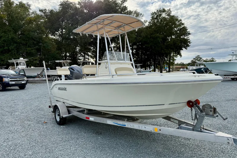 Slide: The Image of 2016 Release 180 CC boat on trailer, parked outdoors with trees in background. - 10