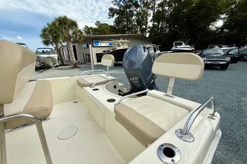 Slide: The Image of 2016 Release 180 CC boat with Yamaha 115 engine, parked outdoors near dealership. - 13
