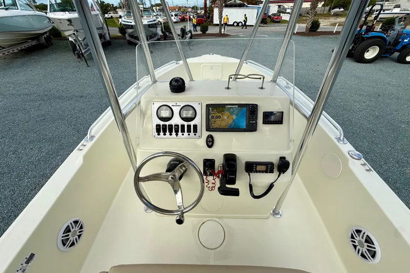 Slide: The Image of 2016 Release 180 CC boat dashboard with steering wheel and navigation equipment. - 18