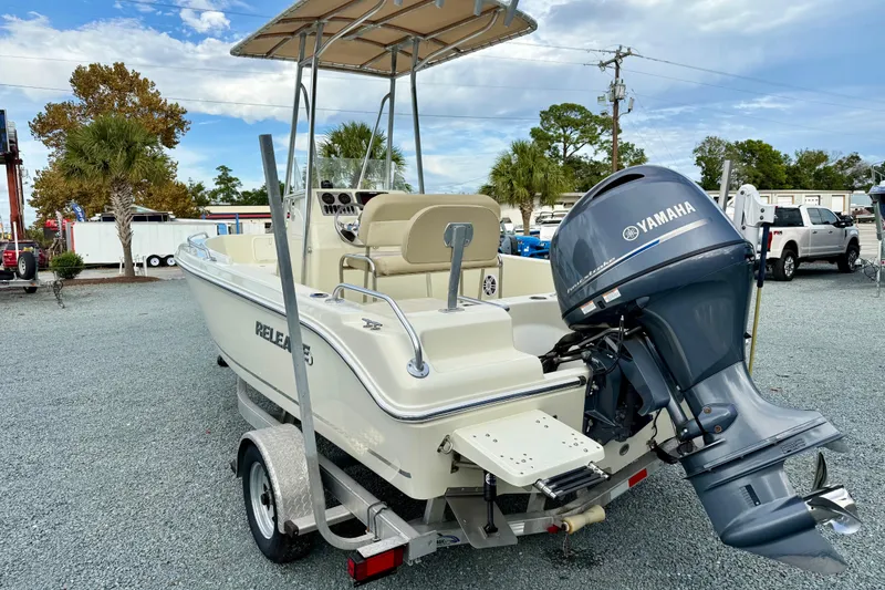 Slide: The Image of 2016 Release 180 CC boat with Yamaha engine on trailer, parked outdoors. - 4
