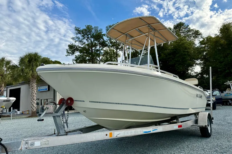 Slide: The Image of 2016 Release 180 CC boat on trailer, parked outdoors under a partly cloudy sky. - 7