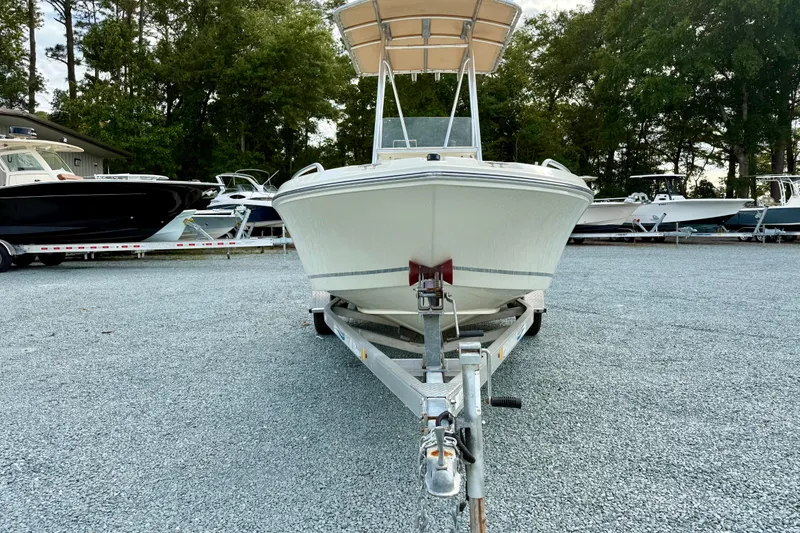 Slide: The Image of 2016 Release 180 CC boat on trailer, surrounded by other boats, in outdoor storage area. - 8