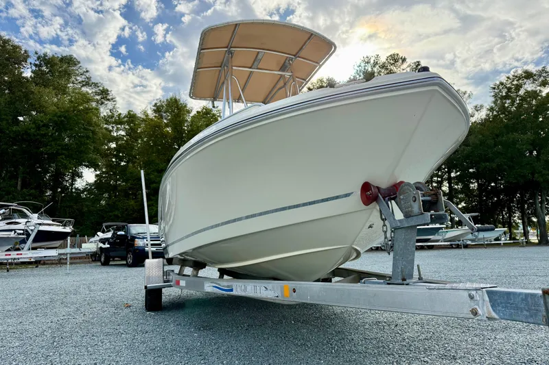 Slide: The Image of 2016 Release 180 CC boat on trailer, parked outdoors under cloudy sky. - 9