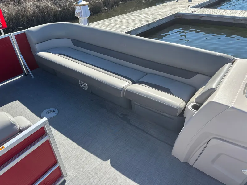 Slide: The Image of 2022 Princecraft 23 Vectra pontoon boat with gray seating, docked by the water. - 10
