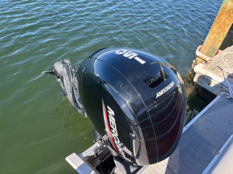 Slide: The Image of Outboard motor on 2022 Princecraft 23 Vectra boat, docked on calm water. - 13