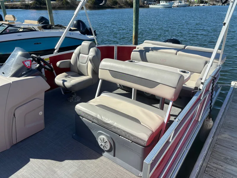 Slide: The Image of 2022 Princecraft 23 Vectra pontoon boat with comfortable seating, docked by the water. - 3