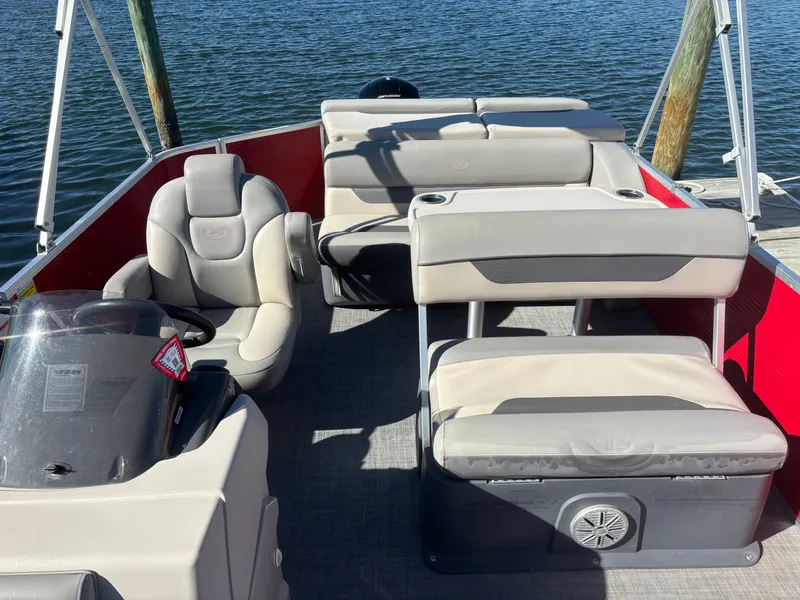 Slide: The Image of 2022 Princecraft 23 Vectra pontoon boat interior with beige seating and steering console. - 4