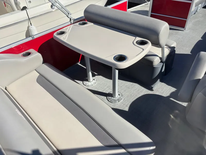 Slide: The Image of 2022 Princecraft 23 Vectra boat interior with seating and table, featuring cup holders. - 6