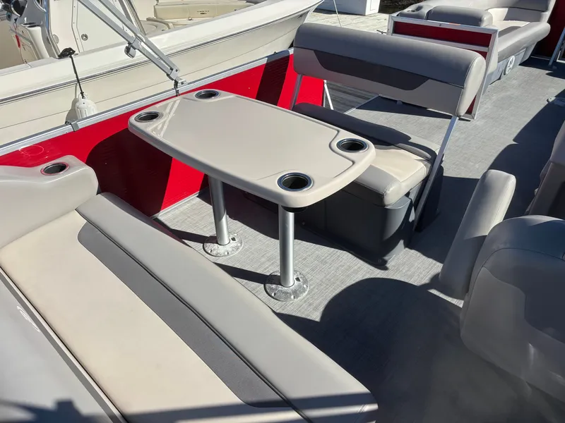 Slide: The Image of 2022 Princecraft 23 Vectra boat interior with seating and table, featuring cup holders. - 7