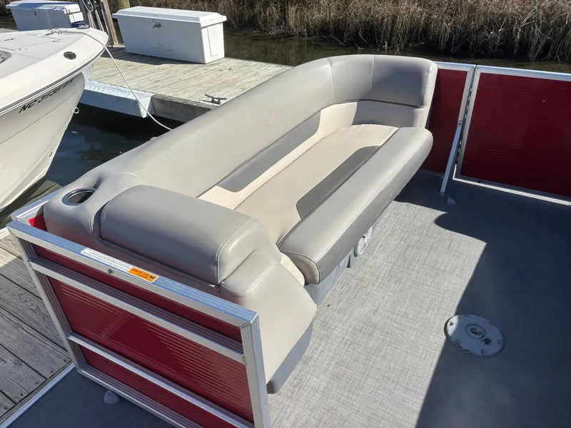 Slide: The Image of 2022 Princecraft 23 Vectra boat with gray seating and red paneling at a dock. - 9