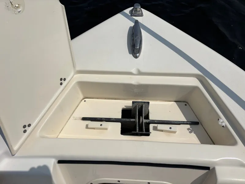 Slide: The Image of 2022 Scout 210 Dorado boat anchor compartment with open hatch, showing anchor storage. - 12