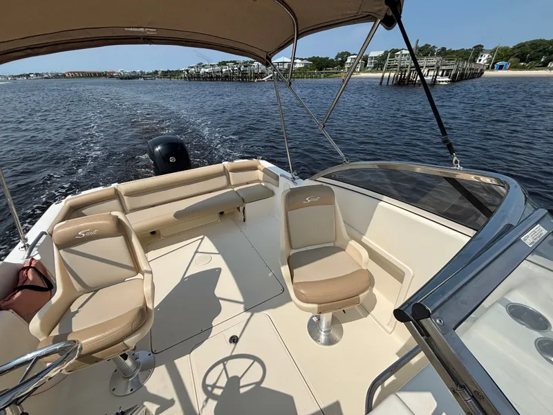 Slide: The Image of 2022 Scout 210 Dorado boat interior with seating, on calm water. - 17