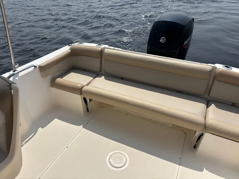 Slide: The Image of 2022 Scout 210 Dorado boat interior with beige seating and outboard motor. - 20