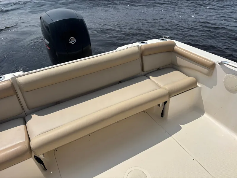 Slide: The Image of 2022 Scout 210 Dorado boat interior with beige seating and outboard motor. - 21