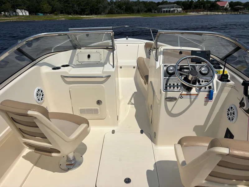 Slide: The Image of 2022 Scout 210 Dorado boat interior with dual seats and steering console. - 22