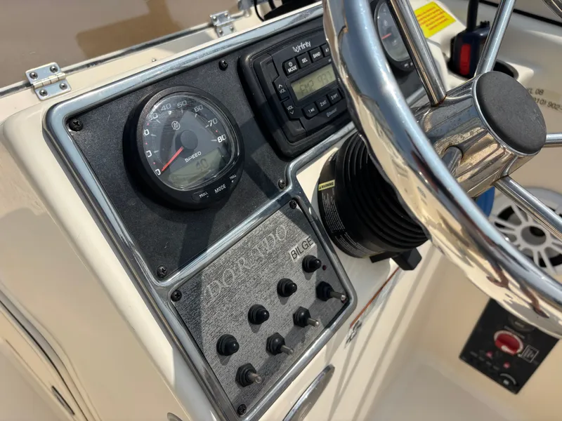 Slide: The Image of 2022 Scout 210 Dorado boat dashboard with speedometer and controls. - 28