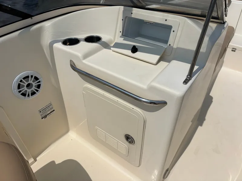 Slide: The Image of 2022 Scout 210 Dorado boat interior with storage compartment and cup holders. - 37