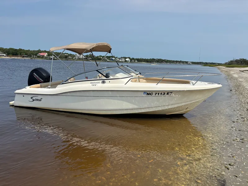 Slide: The Image of 2022 Scout 210 Dorado boat docked on a sandy shoreline. - 5