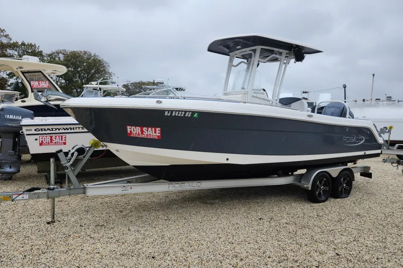 The Image of 2021 Robalo R242 Center Console boat for sale on trailer, displayed outdoors. - 0