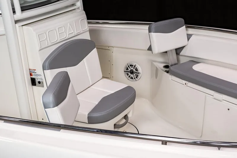 Slide: The Image of 2021 Robalo R242 Center Console boat with Yamaha engine, docked on calm water. - 14