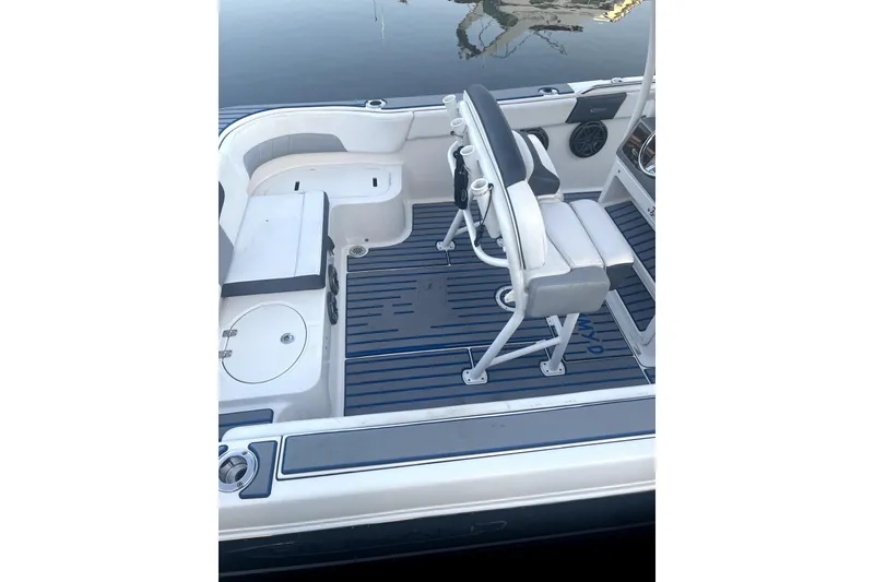 Slide: The Image of 2021 Robalo R242 Center Console boat interior with compass-themed table and seating. - 3