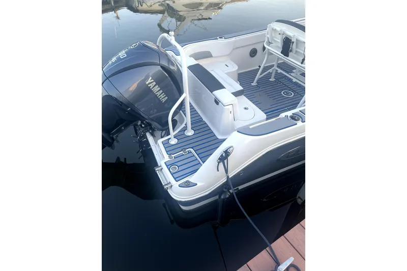 Slide: The Image of 2021 Robalo R242 Center Console boat with modern helm and seating, displayed outdoors. - 4