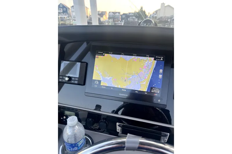 Slide: The Image of 2021 Robalo R242 Center Console boat interior with Garmin system and stylish blue flooring. - 5