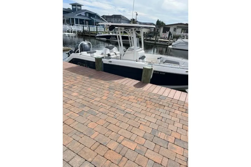 Slide: The Image of 2021 Robalo R242 Center Console boat interior with seating and console details. - 9