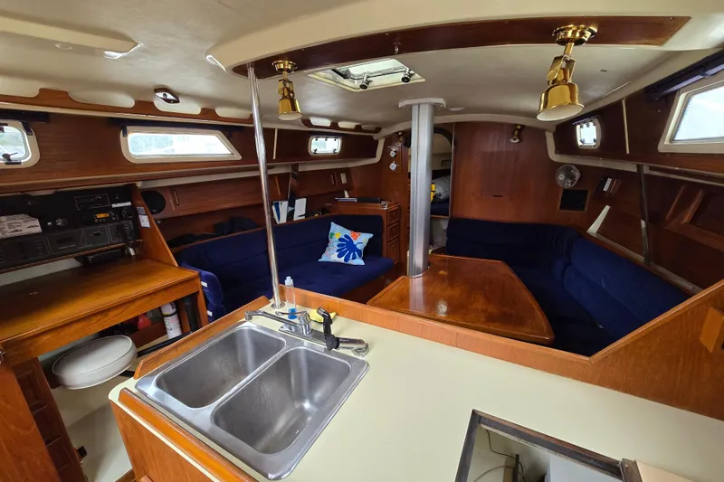 Slide: The Image of 1988 Pearson 362 Centerboard sailboat cockpit with ropes and open cabin entrance. - 10