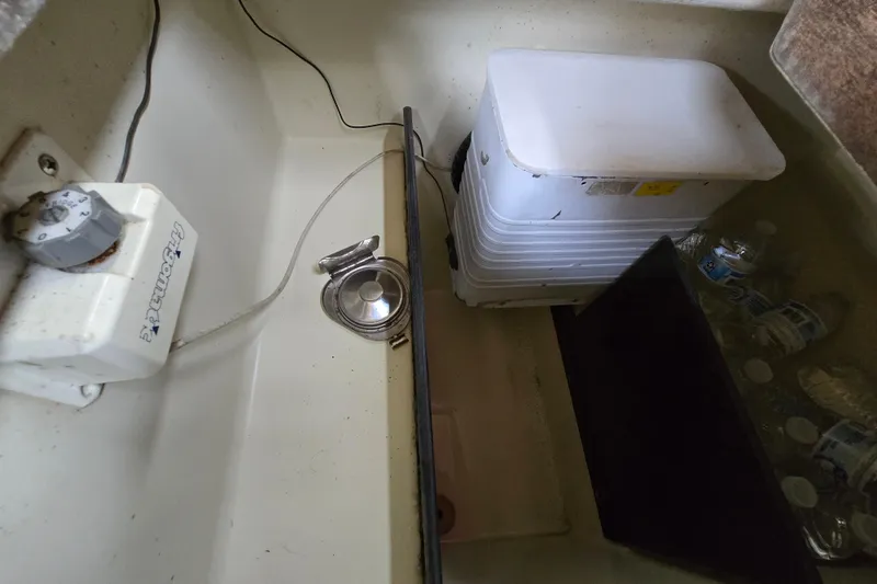 Slide: The Image of Interior of 1988 Pearson 362 Centerboard sailboat, featuring wooden stairs and compact kitchen area. - 11