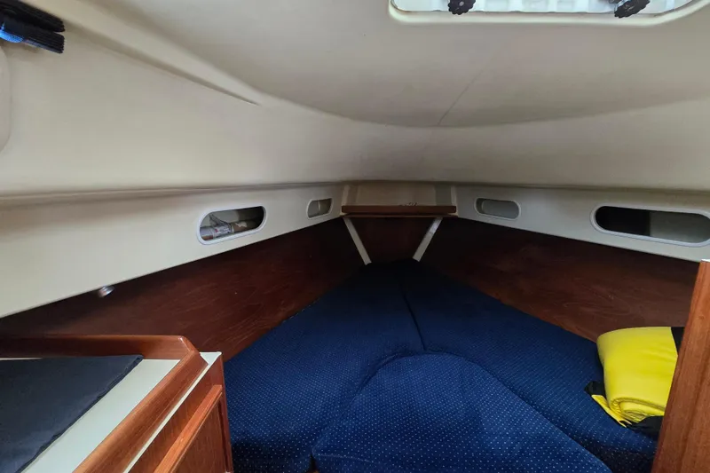 Slide: The Image of Interior of 1988 Pearson 362 Centerboard sailboat with blue upholstery and wooden table. - 13