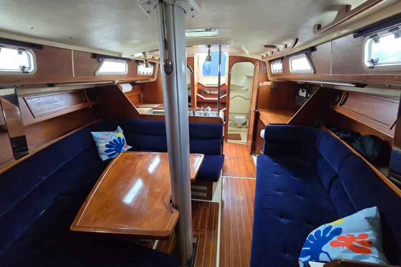 Slide: The Image of 1988 Pearson 362 Centerboard yacht interior with dual sink, stove, and wooden cabinetry. - 14