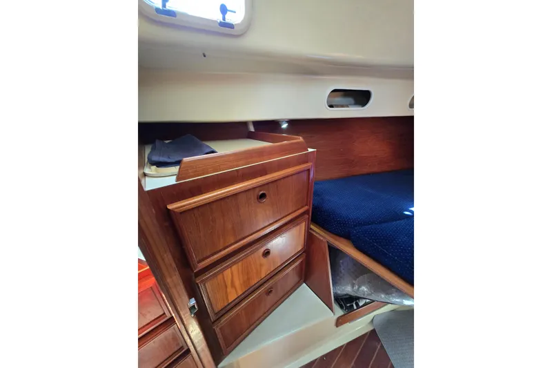 Slide: The Image of Interior of 1988 Pearson 362 Centerboard sailboat with wooden drawers and cozy sleeping area. - 21
