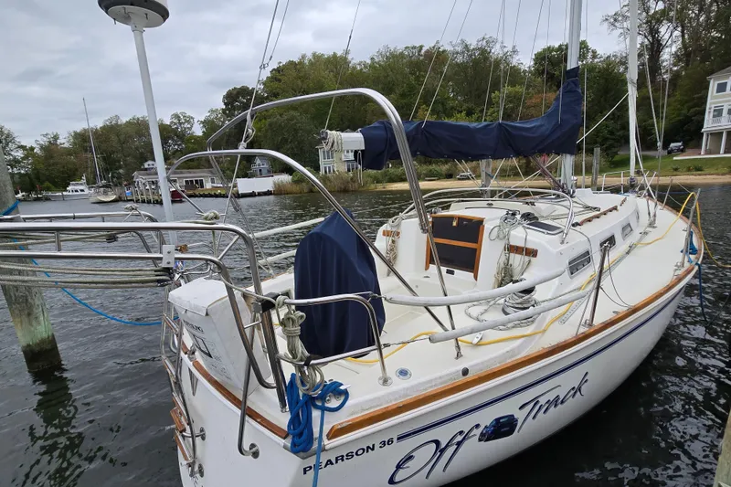 Slide: The Image of 1988 Pearson 362 Centerboard sailboat docked by a scenic waterfront. - 4