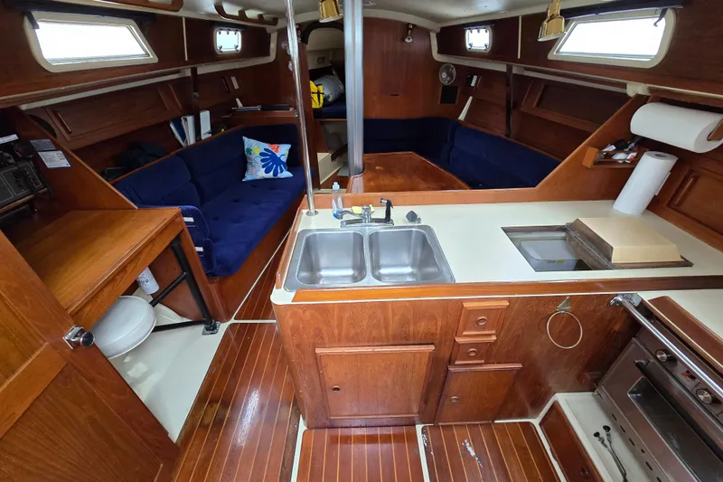 Slide: The Image of Interior of 1988 Pearson 362 Centerboard sailboat with blue cushioned seating. - 5