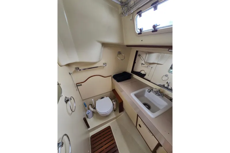 Slide: The Image of 1988 Pearson 362 Centerboard navigation station with control panel and wooden desk. - 9