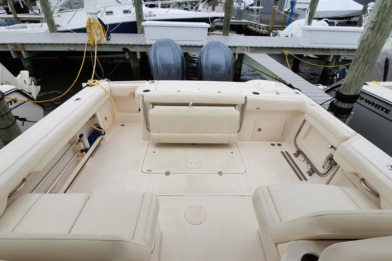 Slide: The Image of 2022 Grady-White Freedom 325 boat interior with seating, docked at marina. - 13
