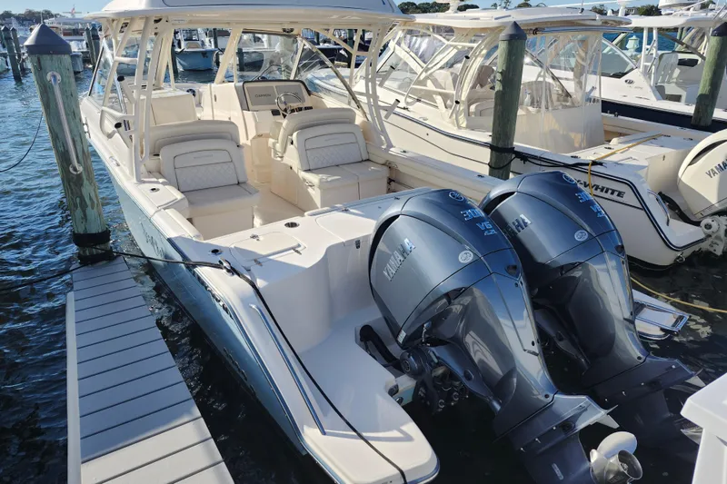 Slide: The Image of 2022 Grady-White Freedom 325 boat with twin Yamaha engines docked at marina. - 2