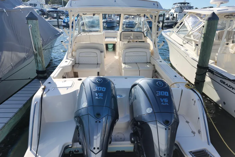 Slide: The Image of 2022 Grady-White Freedom 325 boat with twin Yamaha 300 V6 engines docked at marina. - 3
