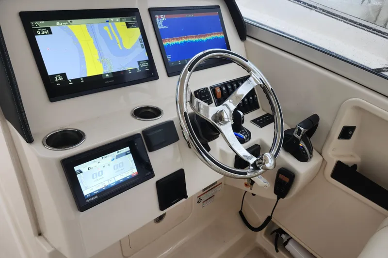 Slide: The Image of 2022 Grady-White Freedom 325 helm with advanced navigation displays and controls. - 5