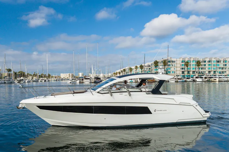 Slide: The Image of 2017 Cruisers Yachts 39 Express Coupe on calm marina waters under blue sky. - 10
