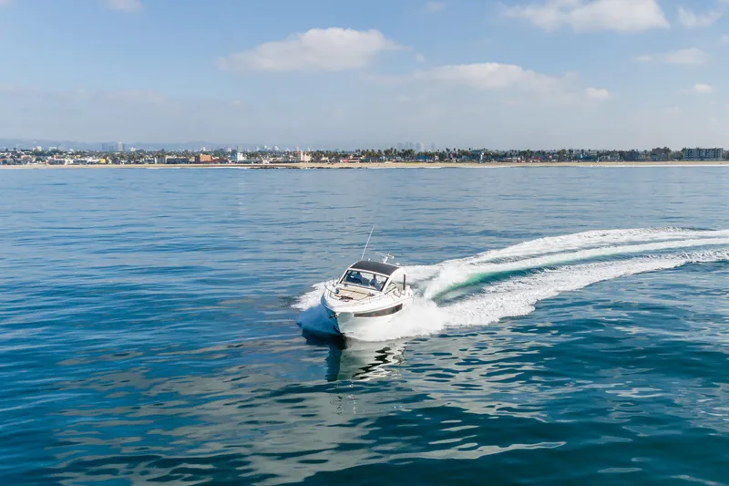 Slide: The Image of 2017 Cruisers Yachts 39 Express Coupe cruising on calm ocean waters. - 16