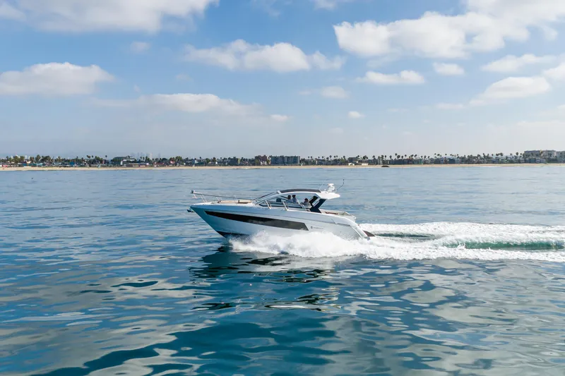 Slide: The Image of 2017 Cruisers Yachts 39 Express Coupe cruising on calm ocean waters. - 17