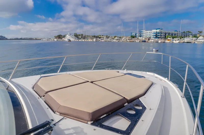 Slide: The Image of 2017 Cruisers Yachts 39 Express Coupe on calm water with marina view. - 23