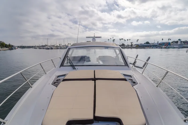 Slide: The Image of 2017 Cruisers Yachts 39 Express Coupe on calm water, showcasing spacious deck and sleek design. - 24