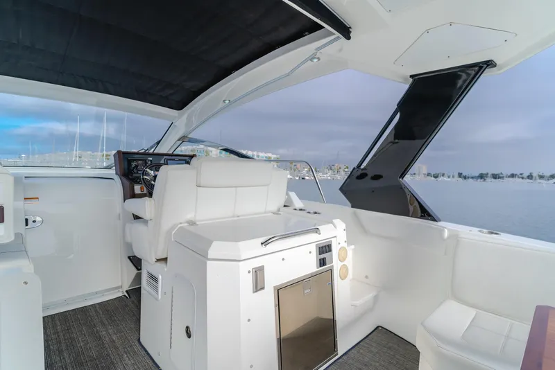 Slide: The Image of 2017 Cruisers Yachts 39 Express Coupe interior with helm, seating, and water view. - 31