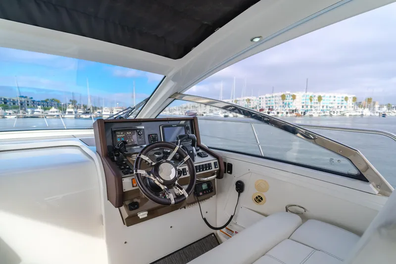 Slide: The Image of 2017 Cruisers Yachts 39 Express Coupe helm with marina view. - 33