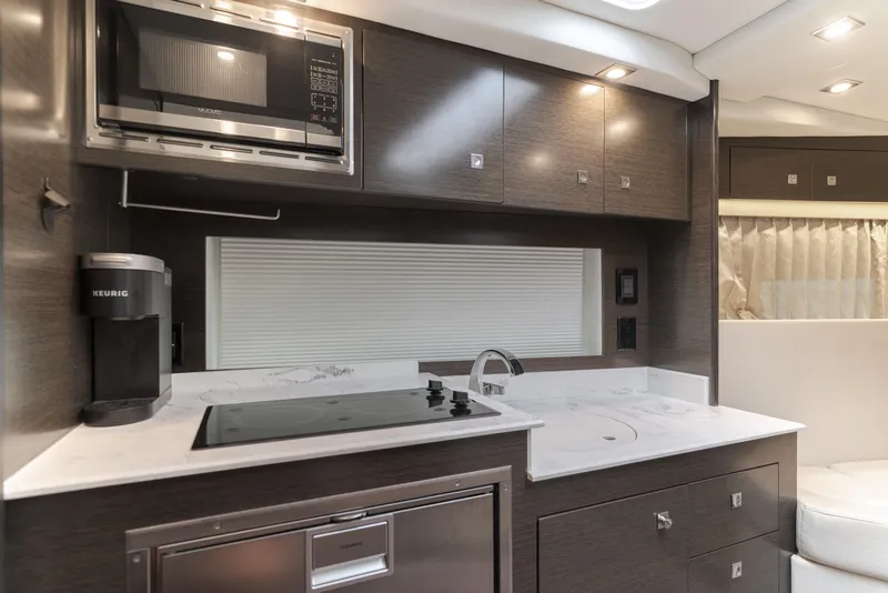 Slide: The Image of 2017 Cruisers Yachts 39 Express Coupe kitchen with modern appliances and sleek cabinetry. - 39
