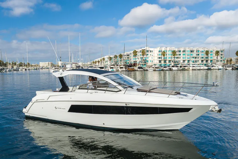 Slide: The Image of 2017 Cruisers Yachts 39 Express Coupe on calm water, marina background. - 4