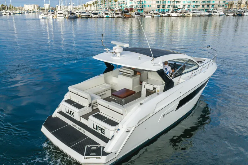 Slide: The Image of 2017 Cruisers Yachts 39 Express Coupe on serene marina waters, showcasing luxury design. - 8